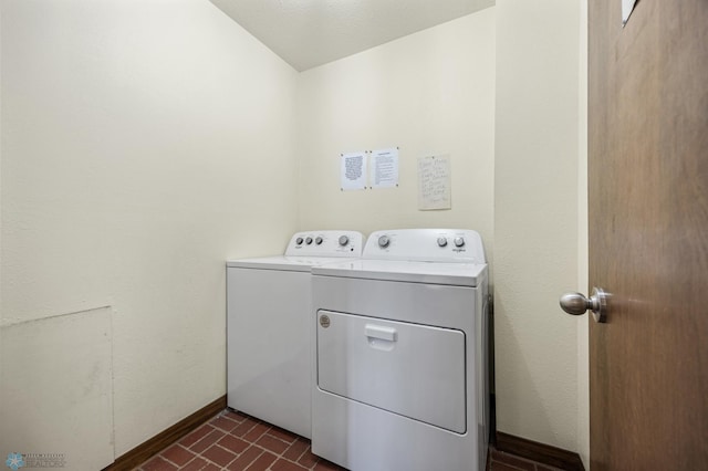 laundry area with brick floor, baseboards, independent washer and dryer, and laundry area