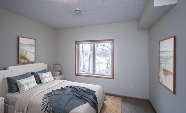 bedroom featuring carpet, a textured ceiling, and baseboards