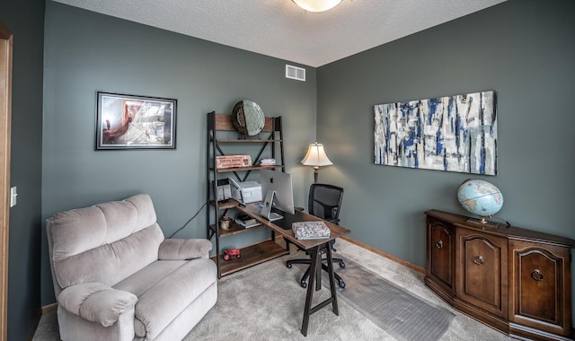 carpeted office featuring visible vents, a textured ceiling, and baseboards