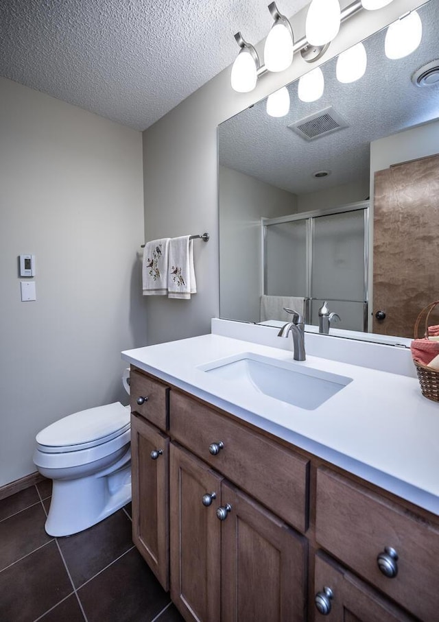 full bathroom featuring a shower stall, vanity, visible vents, and tile patterned floors