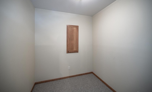 carpeted spare room with baseboards