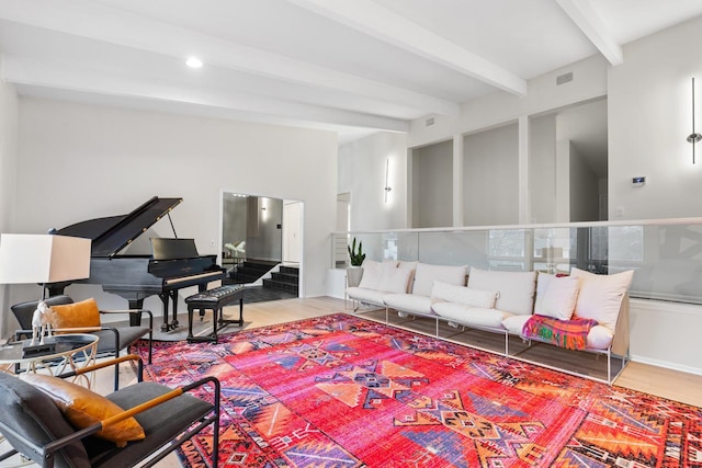 living area with beam ceiling, visible vents, wood finished floors, and recessed lighting