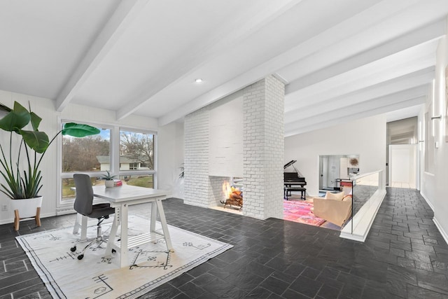 office space with lofted ceiling with beams and a brick fireplace