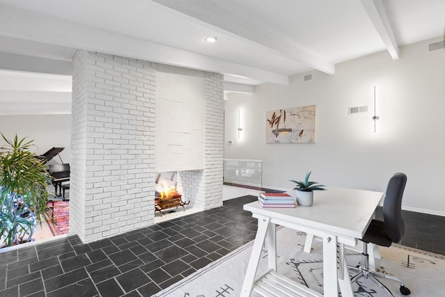 office featuring visible vents, a brick fireplace, and beam ceiling