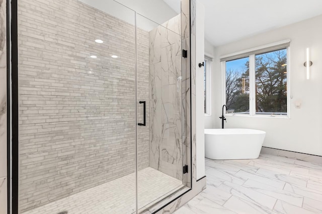 full bath featuring marble finish floor, a soaking tub, and a marble finish shower