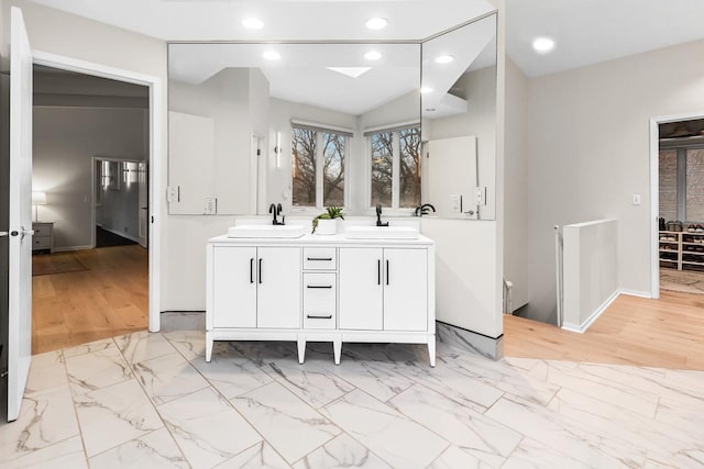 bathroom with recessed lighting, marble finish floor, and a sink