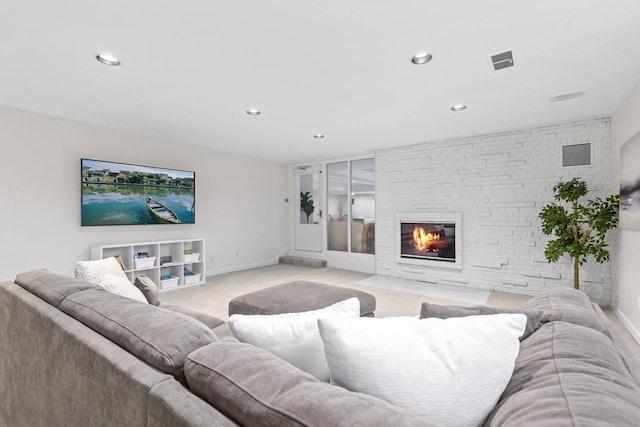 living area featuring a fireplace with flush hearth, visible vents, light carpet, and baseboards