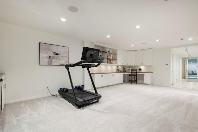 exercise area featuring recessed lighting, light colored carpet, and baseboards