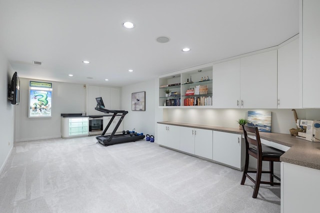 exercise area featuring light carpet, beverage cooler, visible vents, and recessed lighting