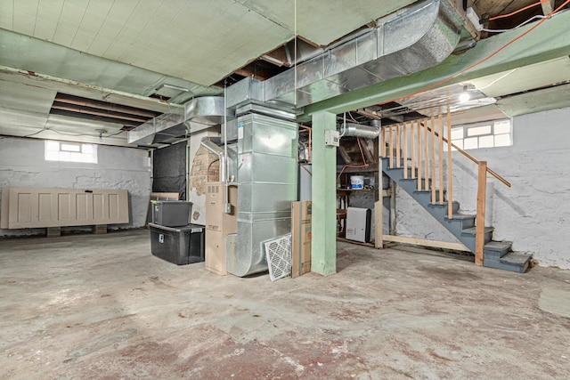 basement featuring stairway and heating unit