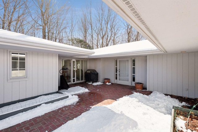 view of snow covered property entrance