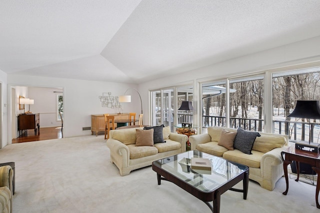 living area featuring light colored carpet, a textured ceiling, and lofted ceiling