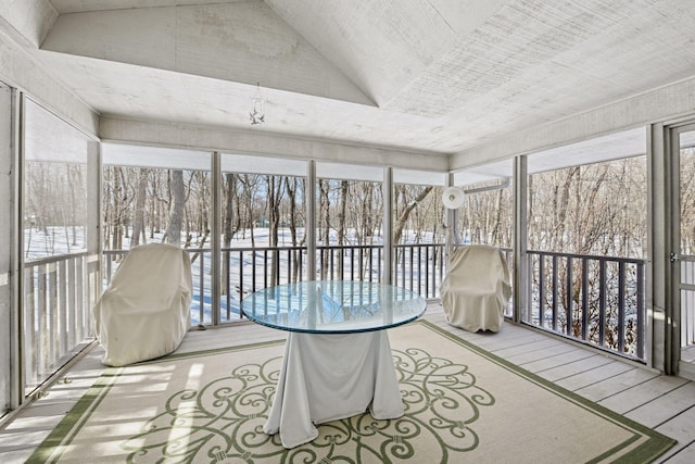 sunroom / solarium featuring vaulted ceiling