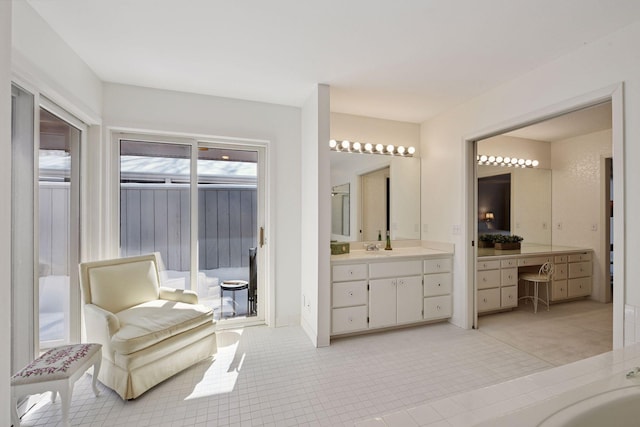 bathroom with vanity, a bathing tub, and tile patterned flooring