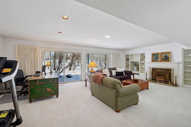 living room with a healthy amount of sunlight, a tile fireplace, a textured ceiling, and carpet