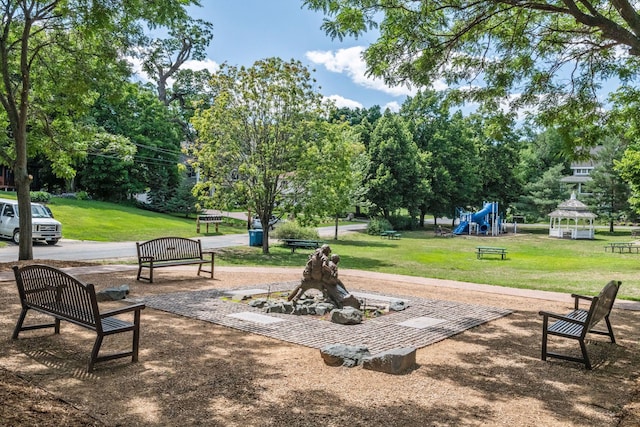 view of community with playground community and a yard