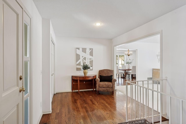 living area with an inviting chandelier, wood finished floors, recessed lighting, and baseboards