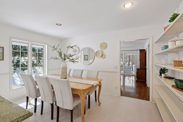 dining room featuring wood finished floors, a wainscoted wall, and recessed lighting