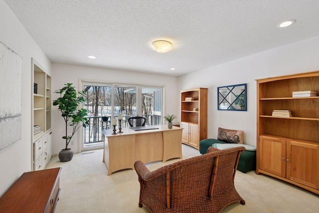 office featuring recessed lighting, light carpet, and a textured ceiling