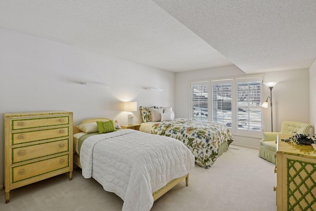 bedroom with a textured ceiling and carpet floors