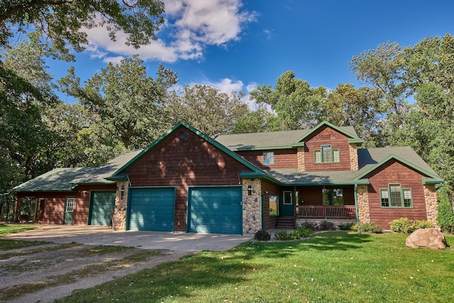 craftsman-style house with covered porch, a garage, driveway, stone siding, and a front yard