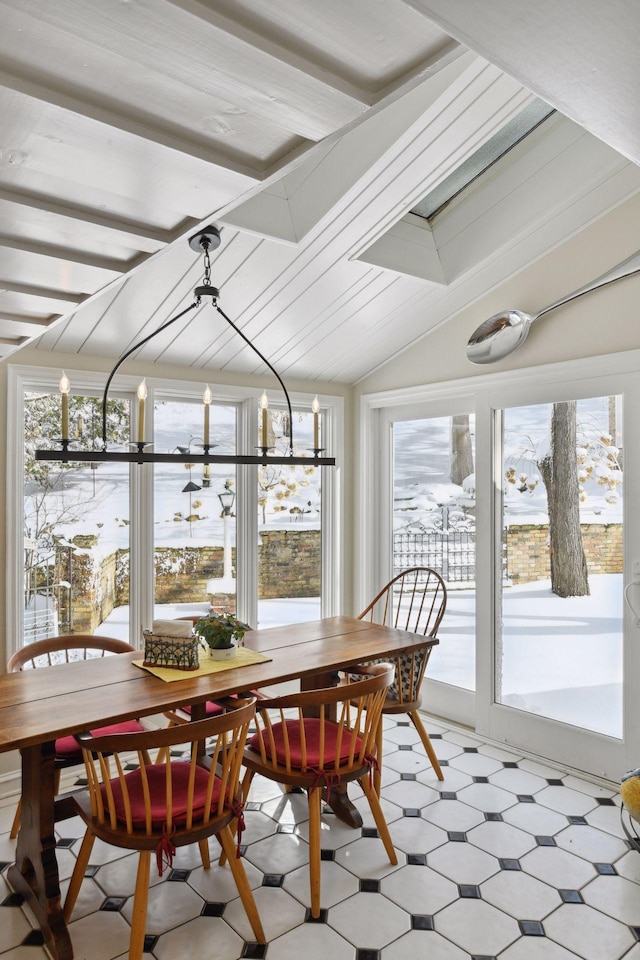 sunroom featuring a chandelier and vaulted ceiling