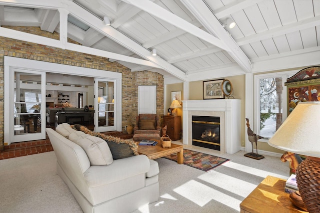 living area featuring a fireplace with flush hearth, carpet flooring, lofted ceiling with beams, and brick wall