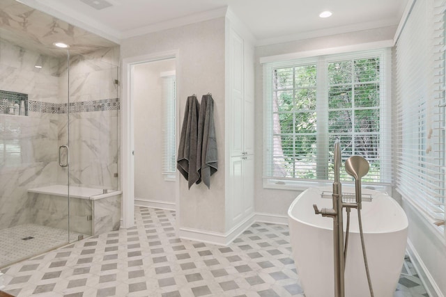 full bath featuring a freestanding tub, a marble finish shower, baseboards, and crown molding