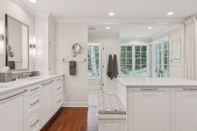 bathroom with visible vents, baseboards, wood finished floors, crown molding, and recessed lighting