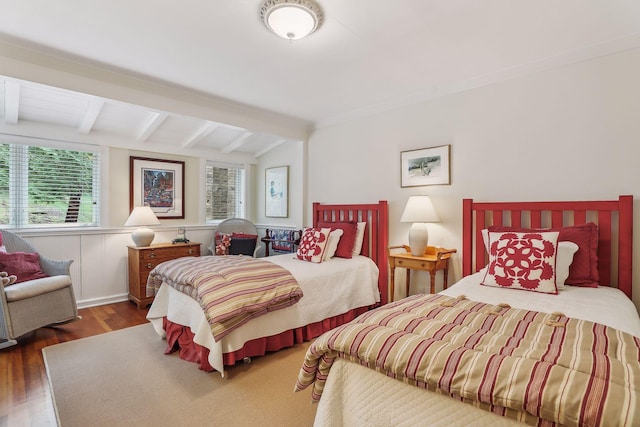 bedroom featuring lofted ceiling with beams and wood finished floors