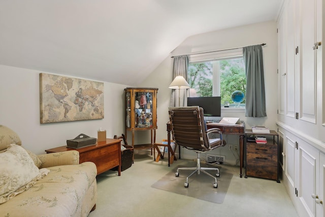 carpeted home office with vaulted ceiling