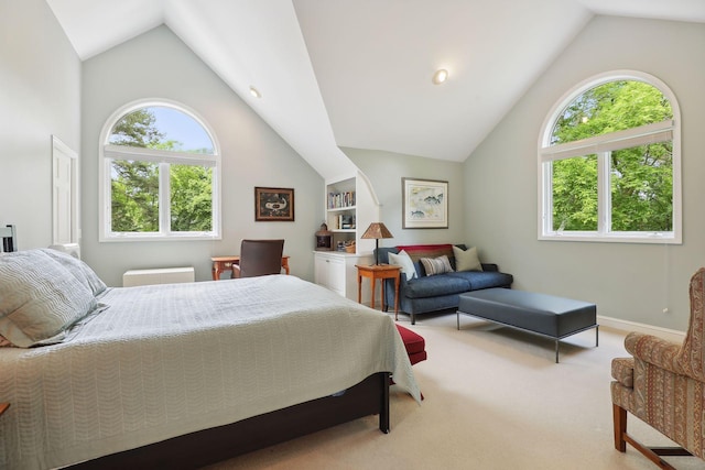 bedroom with carpet floors, multiple windows, and vaulted ceiling