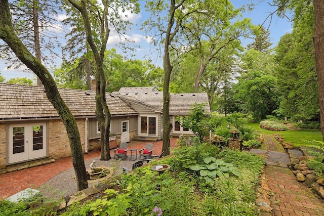 rear view of house with a patio area and brick siding