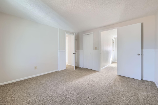 unfurnished bedroom with a closet, carpet flooring, and a textured ceiling