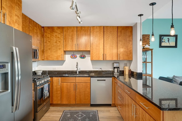929 Portland Ave Unit 309, Minneapolis, MN 55404 - kitchen featuring stainless steel appliances, a peninsula, a sink, light wood-type flooring, and dark stone countertops
