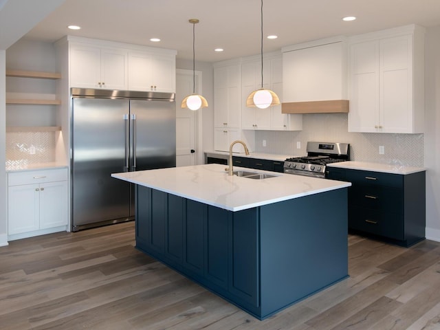 kitchen with custom exhaust hood, open shelves, stainless steel appliances, white cabinetry, and a sink