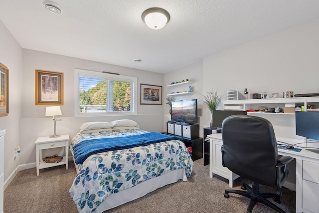 carpeted bedroom with baseboards and a textured ceiling