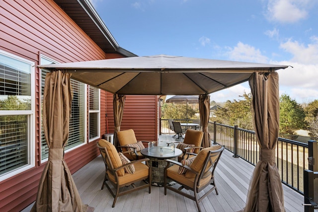 deck featuring outdoor dining space and a gazebo