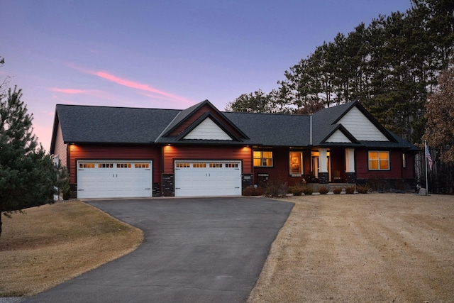 view of front of home featuring a porch, driveway, a shingled roof, and a garage