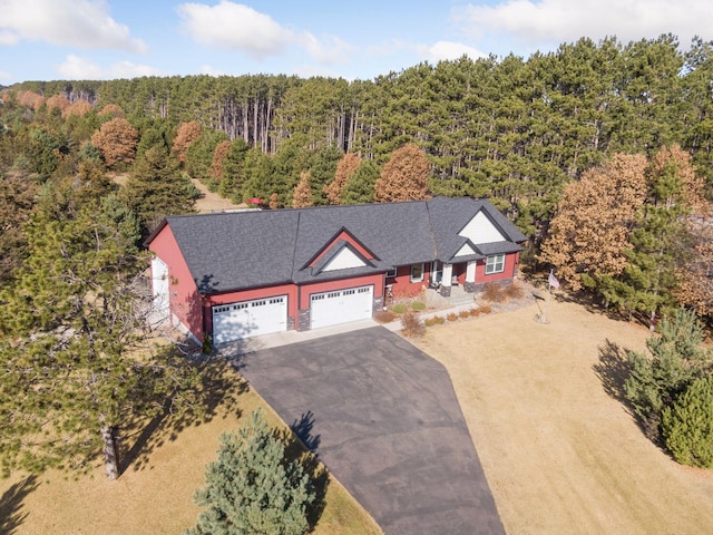 birds eye view of property with a view of trees