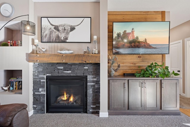 living room with carpet flooring, a fireplace, and baseboards