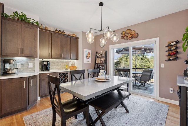 dining area with light wood-style flooring and baseboards