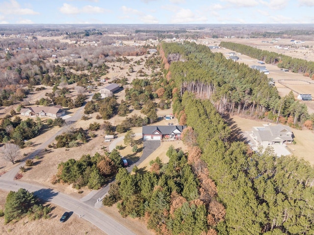 drone / aerial view with a wooded view