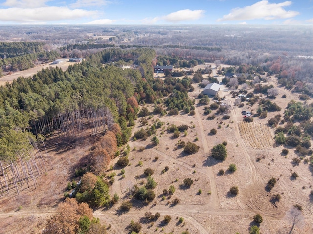 bird's eye view featuring a wooded view