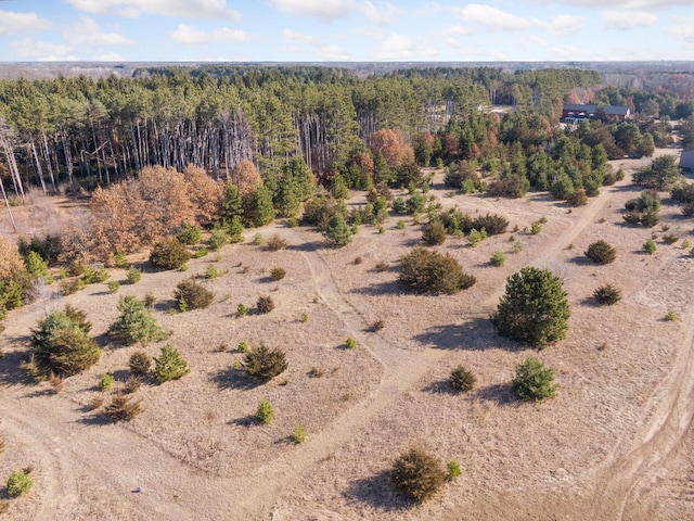 bird's eye view featuring a wooded view