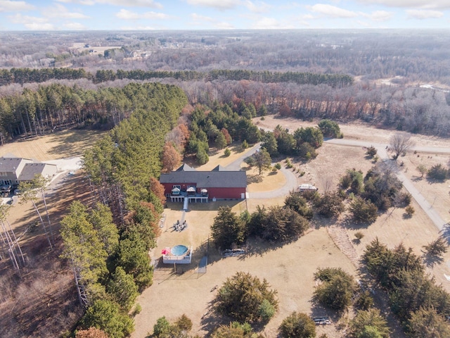 bird's eye view with a wooded view