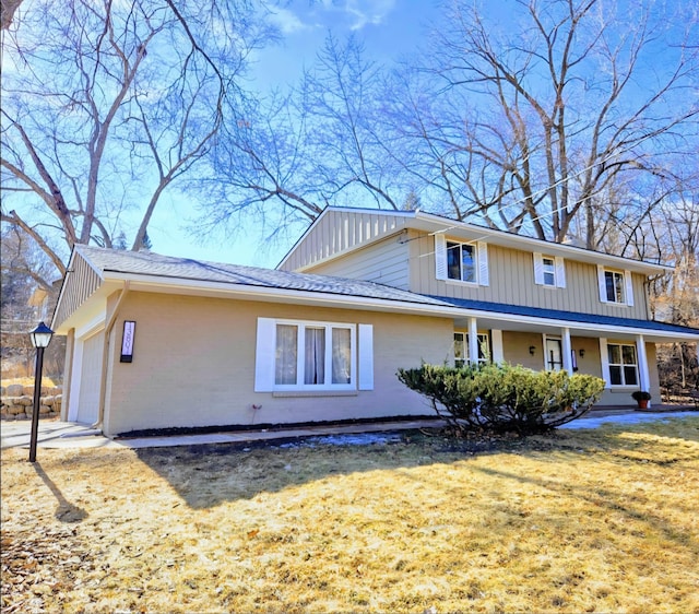 exterior space featuring a garage, a lawn, and a porch