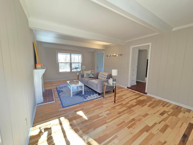 living room with baseboards, wood finished floors, beam ceiling, and crown molding