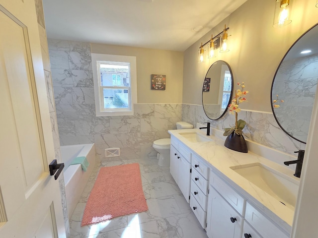 bathroom with a bathtub, marble finish floor, a sink, and toilet