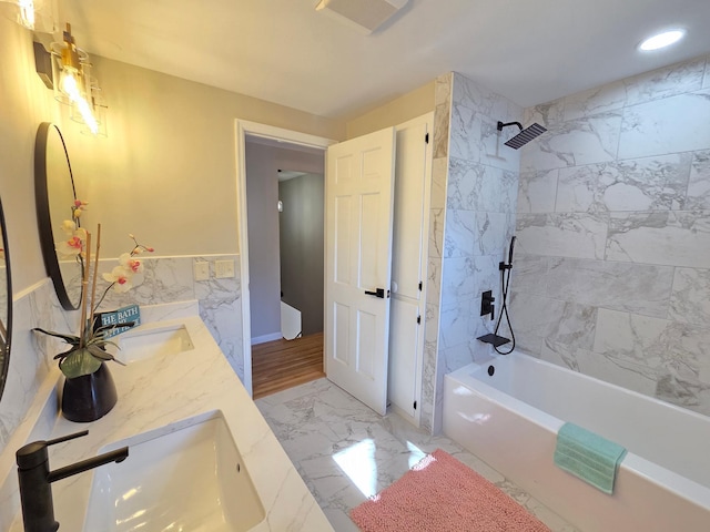 bathroom featuring marble finish floor, shower / tub combination, a sink, and visible vents